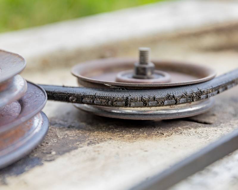 old cracked drive belt pulley on | Lawn Mower Repair: Common Problems And How To Fix Them