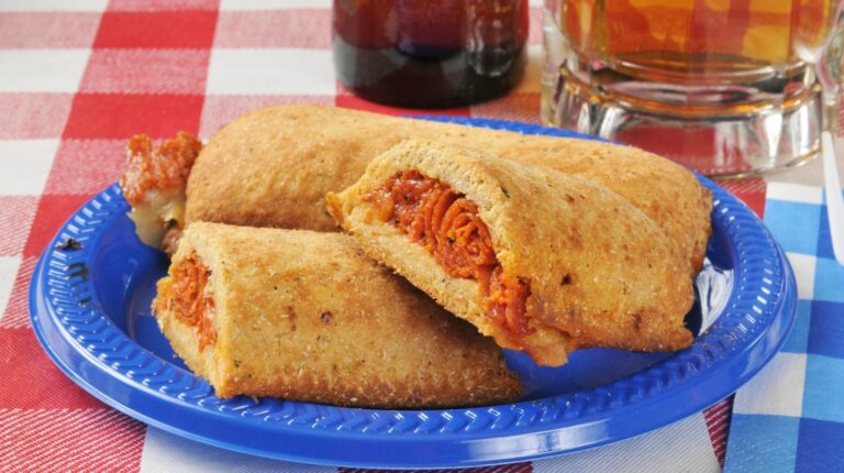 Pizza pockets stuffed with italian meats on a picnic table with beer | Homemade Hot Pockets: Making Home Cooking Worthwhile