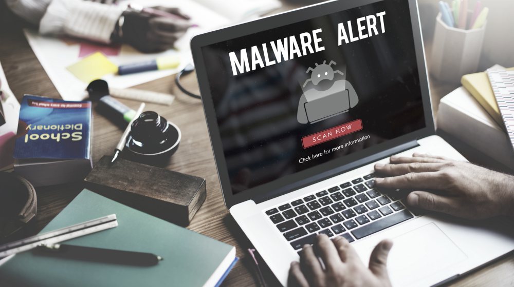 man checking the malware on a laptop | Why Is My Laptop Slow? (And How To Fix It On A Budget) | why is my laptop slow