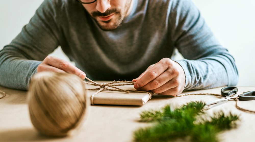 person wrapping gift | Tips For A No-Stress Homemade Holiday | homemade holiday | diy christmas gift ideas