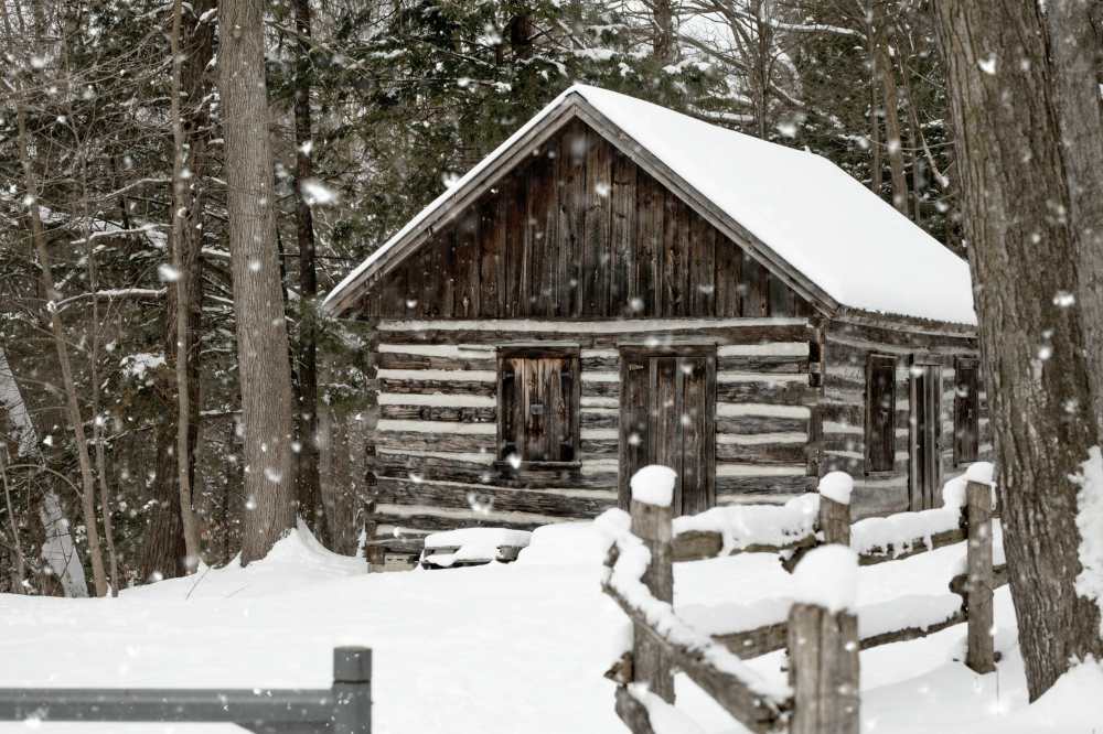 snowy brown house near tree | Winterizing Your Home 101 | Prepare For Winter Months To Come | winterizing your home