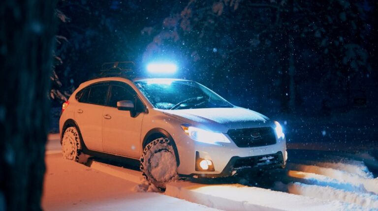 white suv on snow covered road | Emergency Car Kit For Winter Driving Safety | Featured