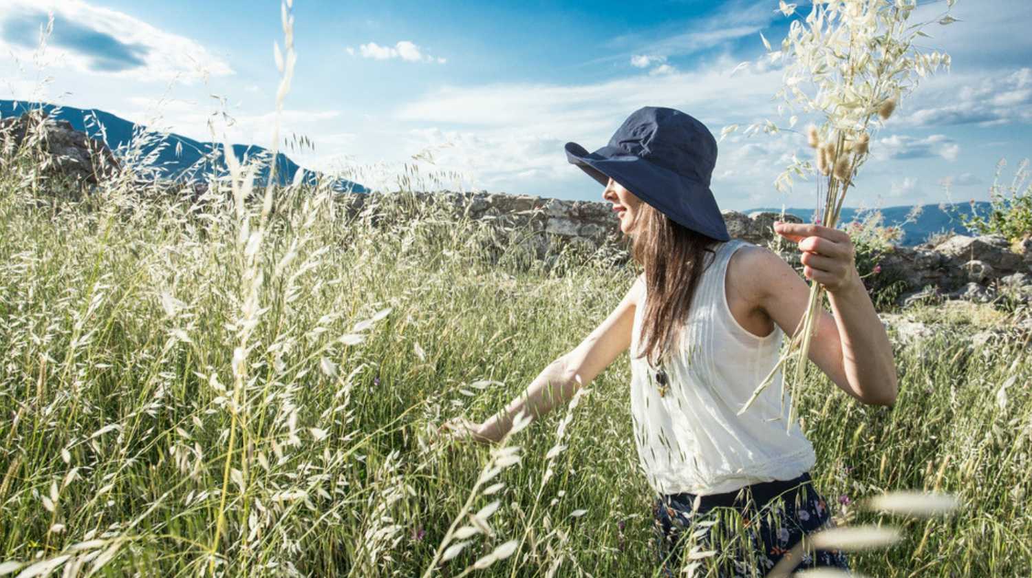 Woman herbalist collecting wild herbs | Secret Survival Garden How To Grow A Hidden Food Supply