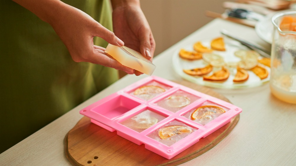 woman taking soap out of the tray | Make Lye Free Soap On The Homestead | Homesteading | Lye Free Soap | lye free soap base recipe
