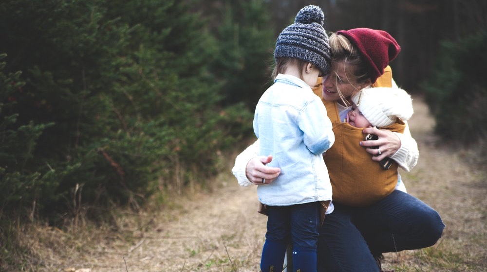 woman with baby | Last Minute Mother's Day Gifts For Homesteading Moms | featured
