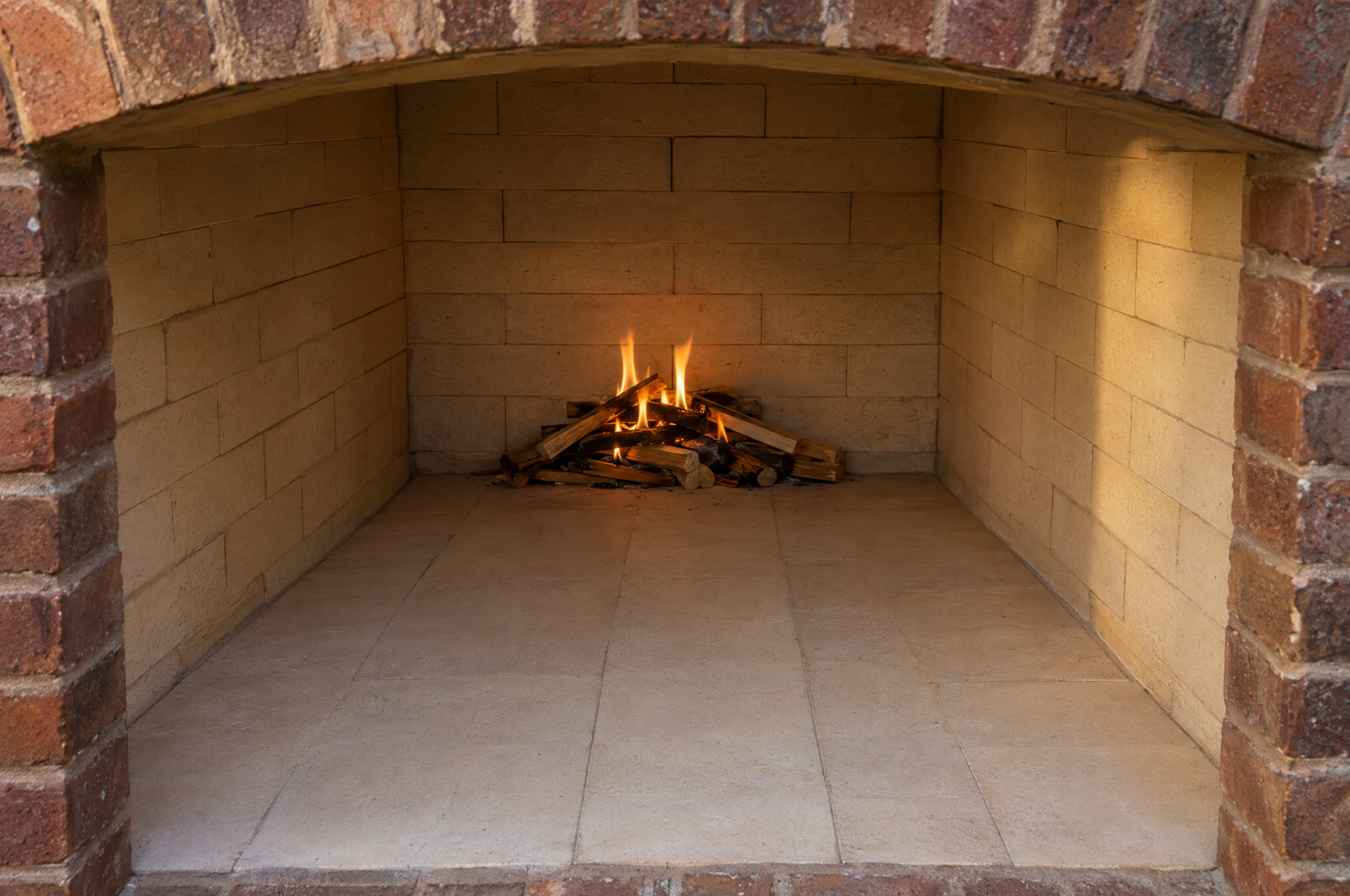 Small first curing fire at the back of a new brick firebox